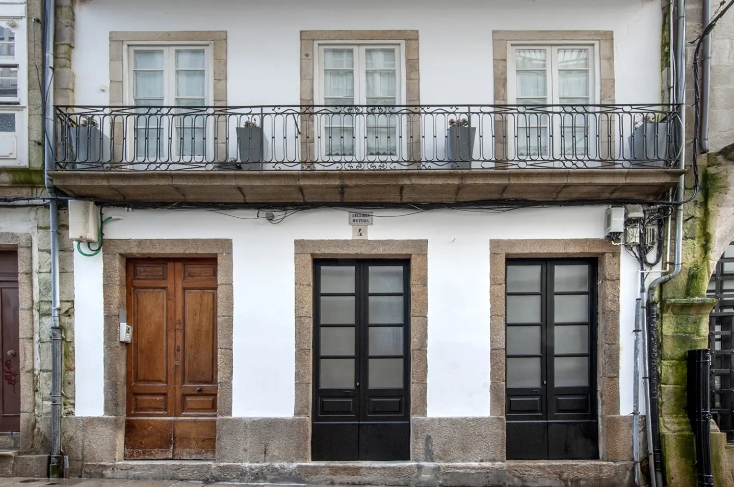 La fachada conservada, con su balcón de forja original